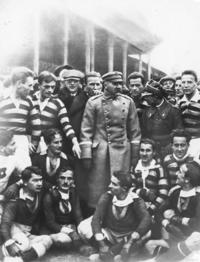 Piłsudski w otoczeniu piłkarzy obu drużyn.